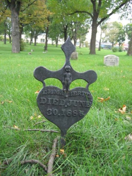 “The babies [from the Baby Farm on Nicollet Avenue] are buried in unmarked graves at various locations throughout the cemetery.” This heart shaped grave marker is for Emma Bertta who died June 30th 1886, marker of a heart shaped cross and whose family did provide this marker. 