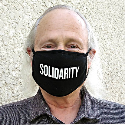 A picture of the author with a black face mask reading 'Solidarity'